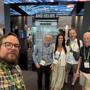 A photo of the 5 attendees from IT Services. A man with glasses, a beard and yellow shirt is taking a selfie of everyone, There are 3 men and 1 woman in the group. One man has dark hair and glasses, another is tall and bald wearing a white shirt. The other is blonde and is wearing a dark shirt and tailored shorts. The woman has long dark brown hair and is wearing long beige trousers and a white top.
